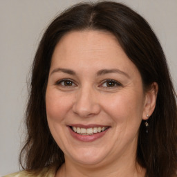 Joyful white adult female with medium  brown hair and brown eyes