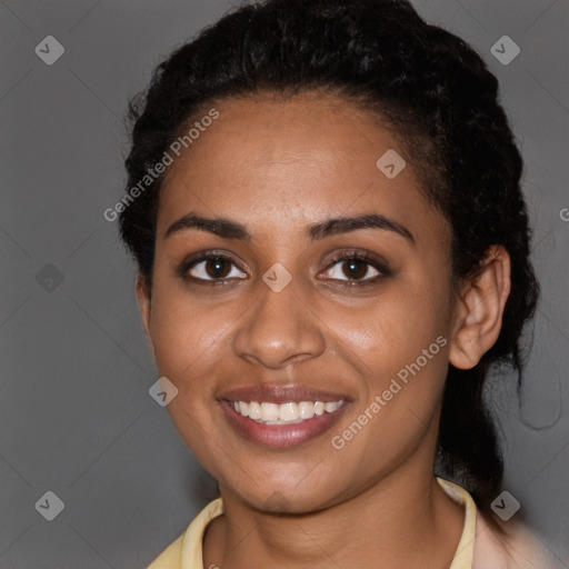 Joyful black young-adult female with short  black hair and brown eyes