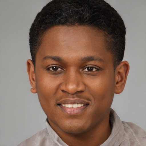 Joyful black young-adult male with short  brown hair and brown eyes