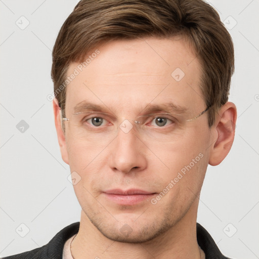 Joyful white young-adult male with short  brown hair and grey eyes