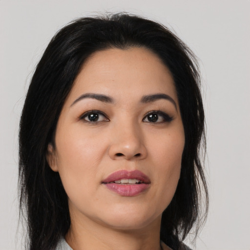 Joyful latino young-adult female with medium  black hair and brown eyes