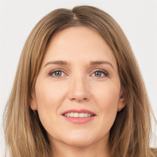 Joyful white young-adult female with long  brown hair and brown eyes