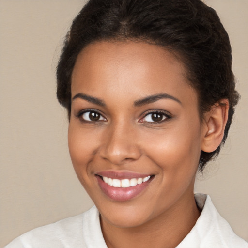 Joyful black young-adult female with medium  brown hair and brown eyes