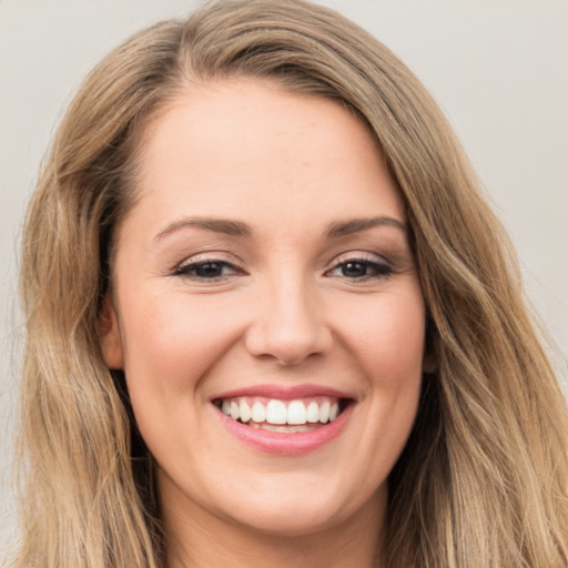 Joyful white young-adult female with long  brown hair and brown eyes