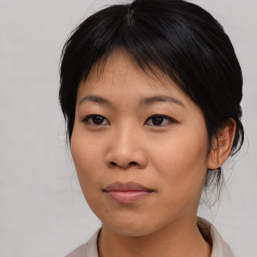 Joyful asian young-adult female with medium  brown hair and brown eyes