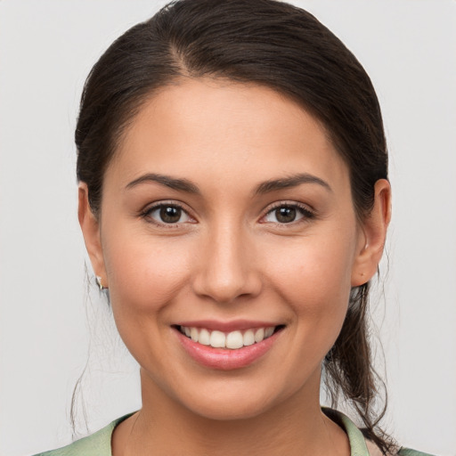 Joyful white young-adult female with medium  brown hair and brown eyes