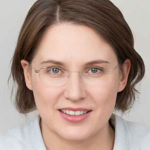 Joyful white adult female with medium  brown hair and grey eyes