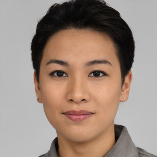 Joyful asian young-adult female with short  black hair and brown eyes