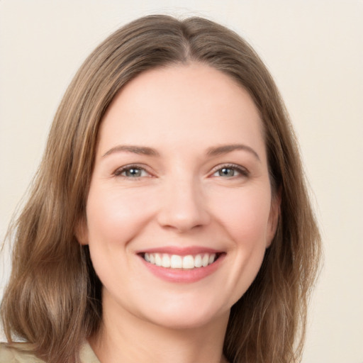 Joyful white young-adult female with medium  brown hair and green eyes