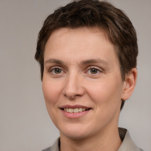 Joyful white adult female with short  brown hair and grey eyes