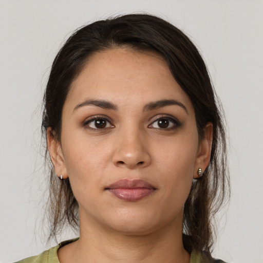 Joyful latino young-adult female with medium  brown hair and brown eyes