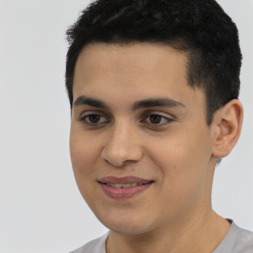 Joyful latino young-adult male with short  black hair and brown eyes
