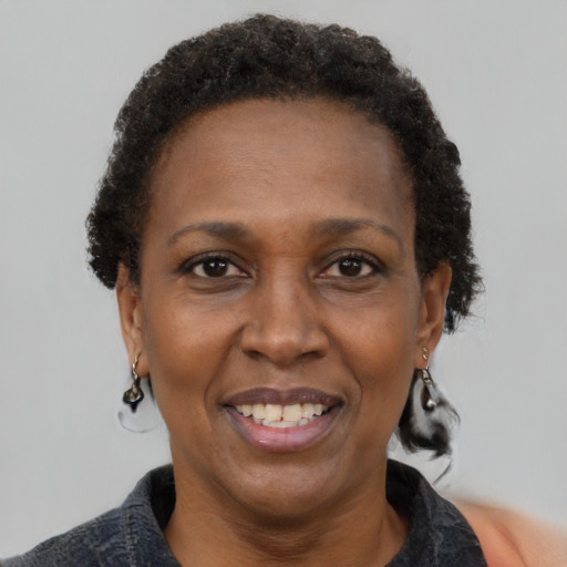Joyful black adult female with short  brown hair and brown eyes