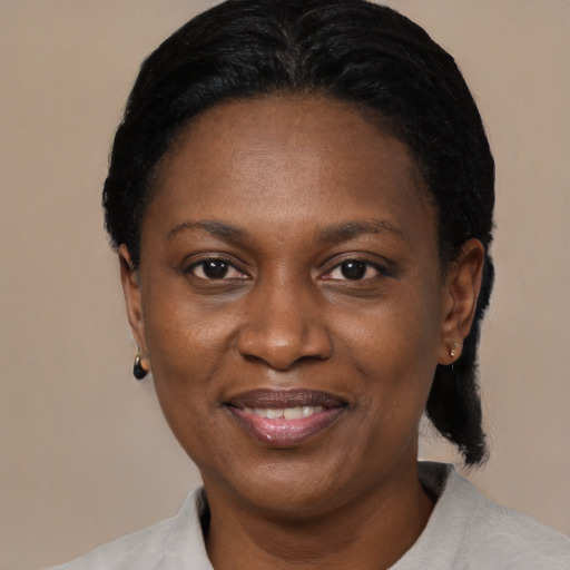 Joyful black adult female with short  black hair and brown eyes