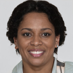 Joyful black adult female with short  brown hair and brown eyes