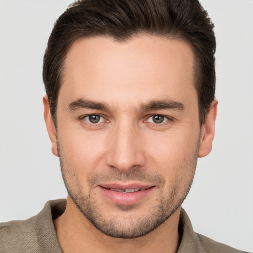 Joyful white young-adult male with short  brown hair and brown eyes