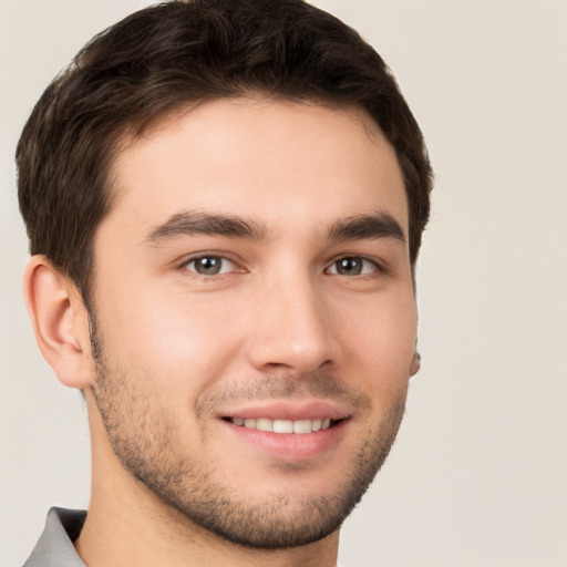 Joyful white young-adult male with short  brown hair and brown eyes