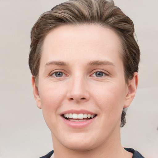 Joyful white young-adult female with short  brown hair and grey eyes