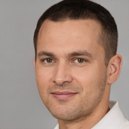 Joyful white adult male with short  brown hair and brown eyes