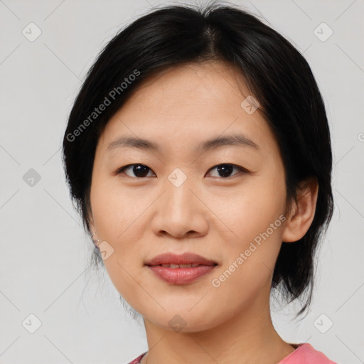 Joyful asian young-adult female with medium  black hair and brown eyes