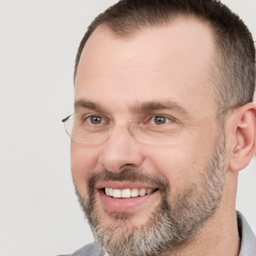 Joyful white adult male with short  brown hair and brown eyes