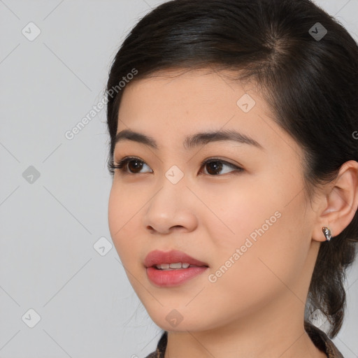 Joyful asian young-adult female with medium  brown hair and brown eyes