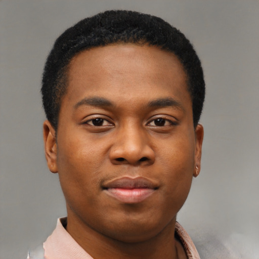Joyful black young-adult male with short  brown hair and brown eyes