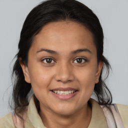 Joyful latino young-adult female with medium  brown hair and brown eyes