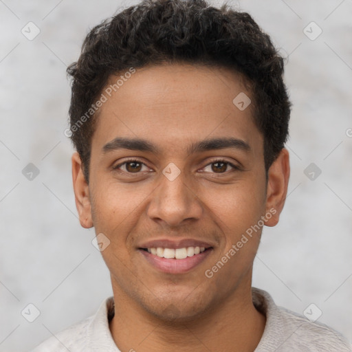 Joyful latino young-adult male with short  brown hair and brown eyes