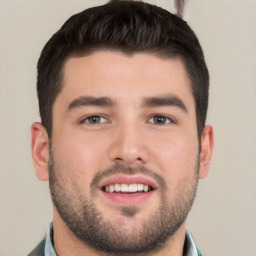 Joyful white young-adult male with short  black hair and brown eyes