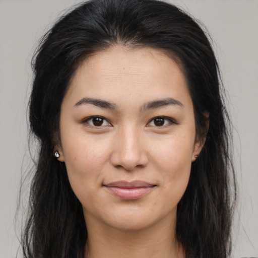 Joyful latino young-adult female with long  brown hair and brown eyes