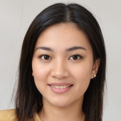 Joyful asian young-adult female with long  brown hair and brown eyes