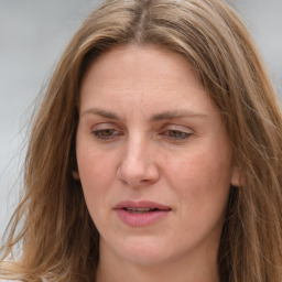 Joyful white adult female with long  brown hair and brown eyes