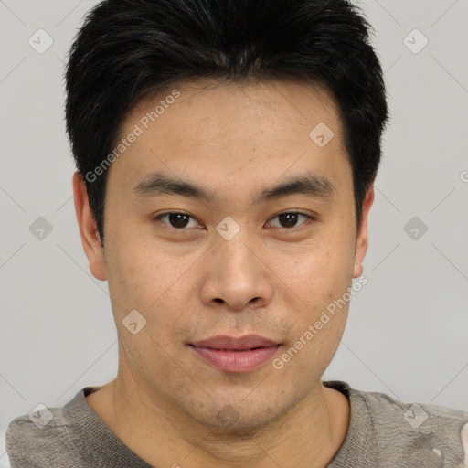 Joyful asian young-adult male with short  black hair and brown eyes
