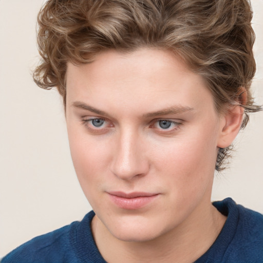 Joyful white young-adult female with short  brown hair and blue eyes