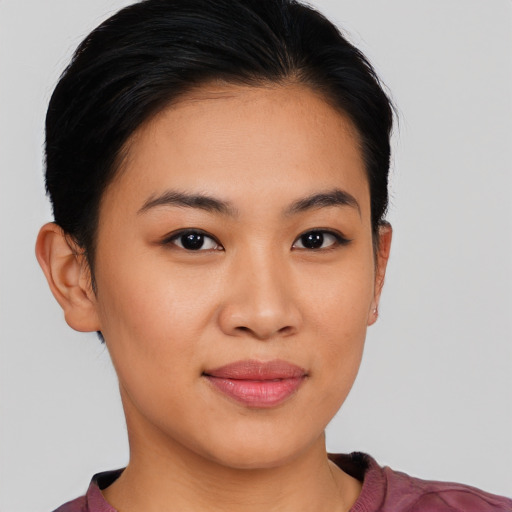 Joyful latino young-adult female with short  brown hair and brown eyes