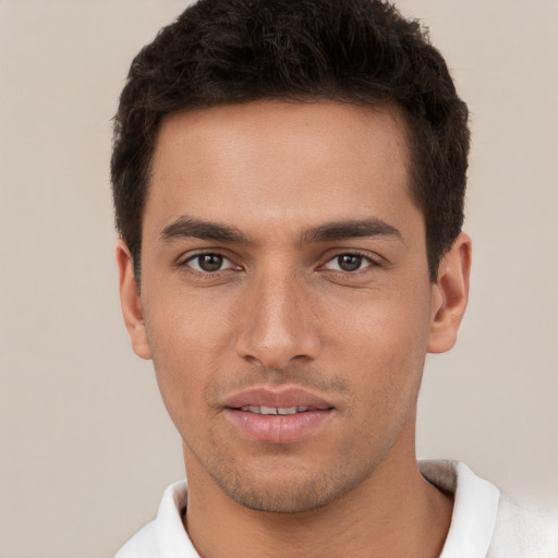 Joyful white young-adult male with short  brown hair and brown eyes