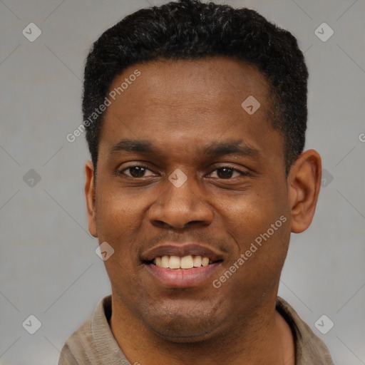 Joyful black young-adult male with short  black hair and brown eyes