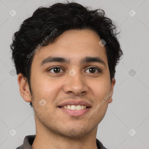 Joyful latino young-adult male with short  brown hair and brown eyes