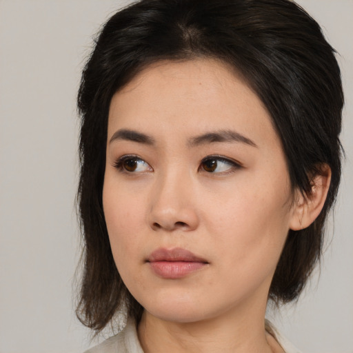 Neutral asian young-adult female with medium  brown hair and brown eyes