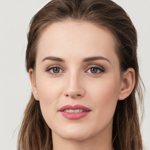 Joyful white young-adult female with long  brown hair and grey eyes