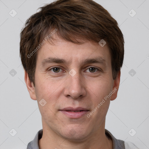 Joyful white adult male with short  brown hair and grey eyes