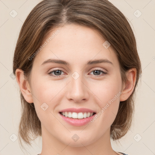 Joyful white young-adult female with medium  brown hair and green eyes