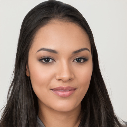 Joyful latino young-adult female with long  brown hair and brown eyes