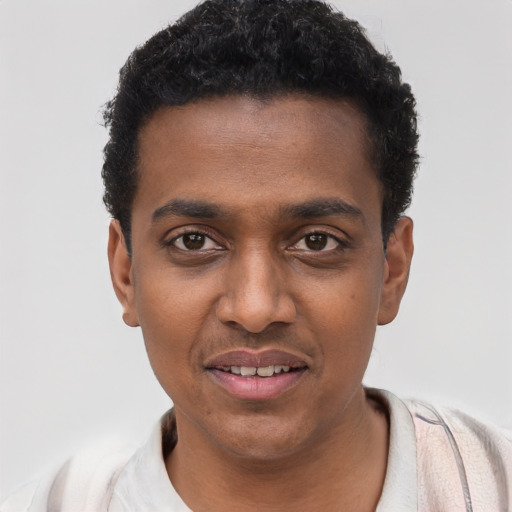 Joyful black young-adult male with short  black hair and brown eyes