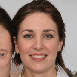 Joyful white adult female with medium  brown hair and brown eyes