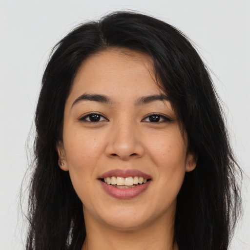 Joyful asian young-adult female with long  brown hair and brown eyes