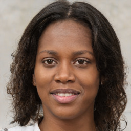 Joyful black young-adult female with medium  brown hair and brown eyes