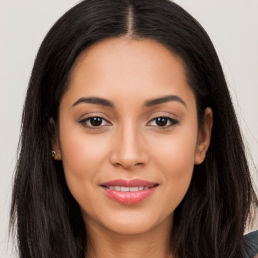 Joyful latino young-adult female with long  black hair and brown eyes