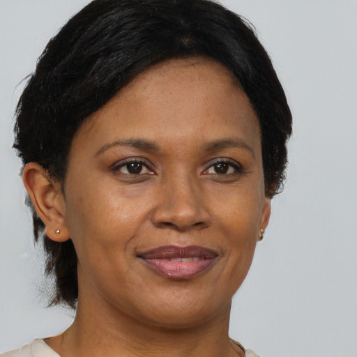 Joyful black adult female with short  brown hair and brown eyes